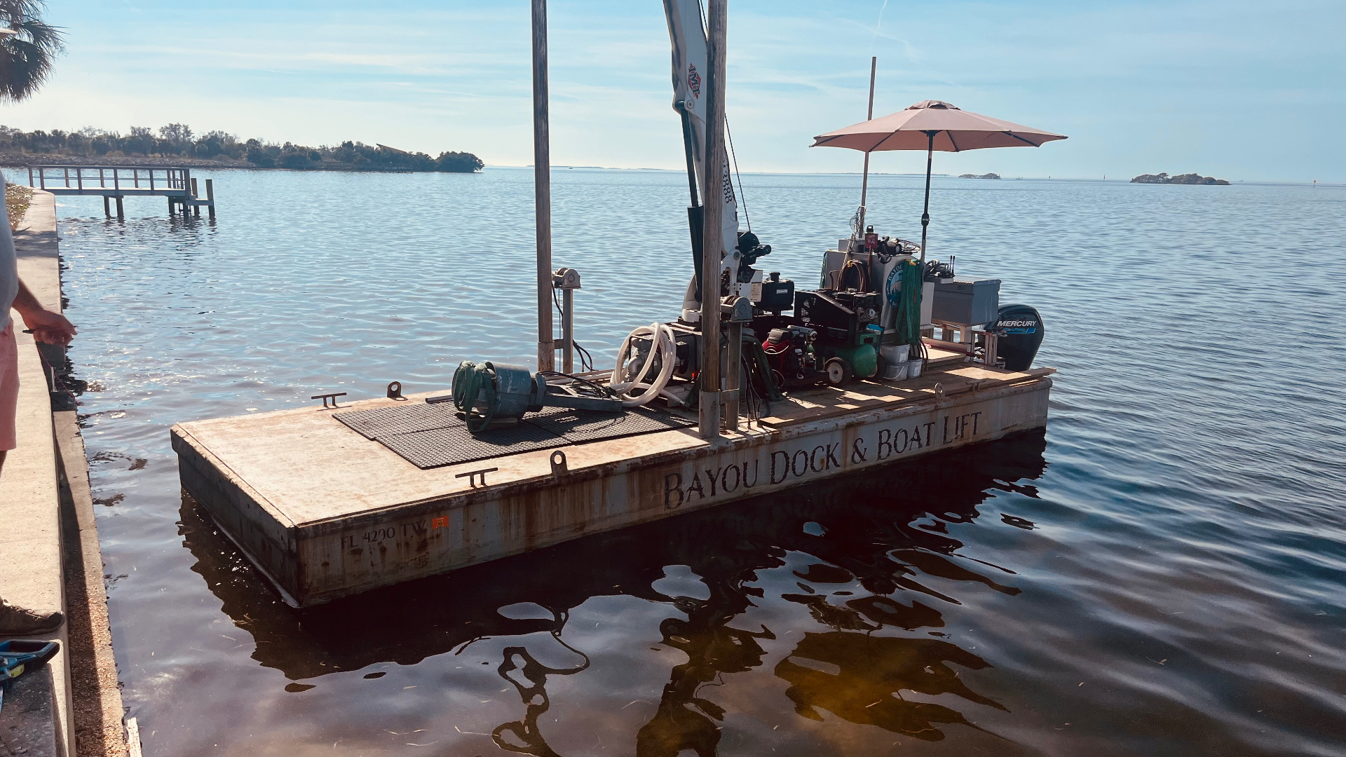 Bayou Dock & Boat Lift work barge on the water